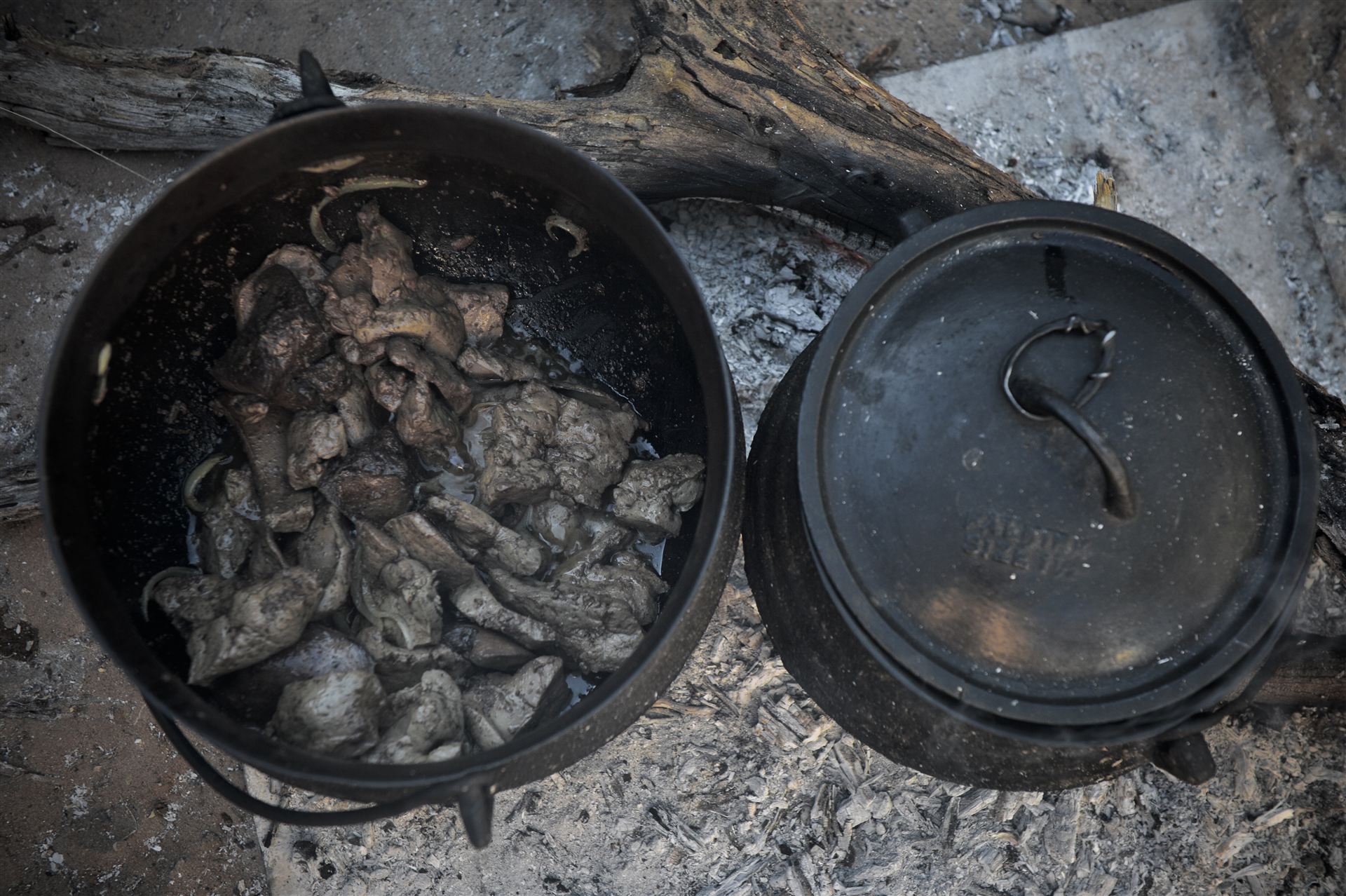 Slow-cooked meat in cast iron potjie pots