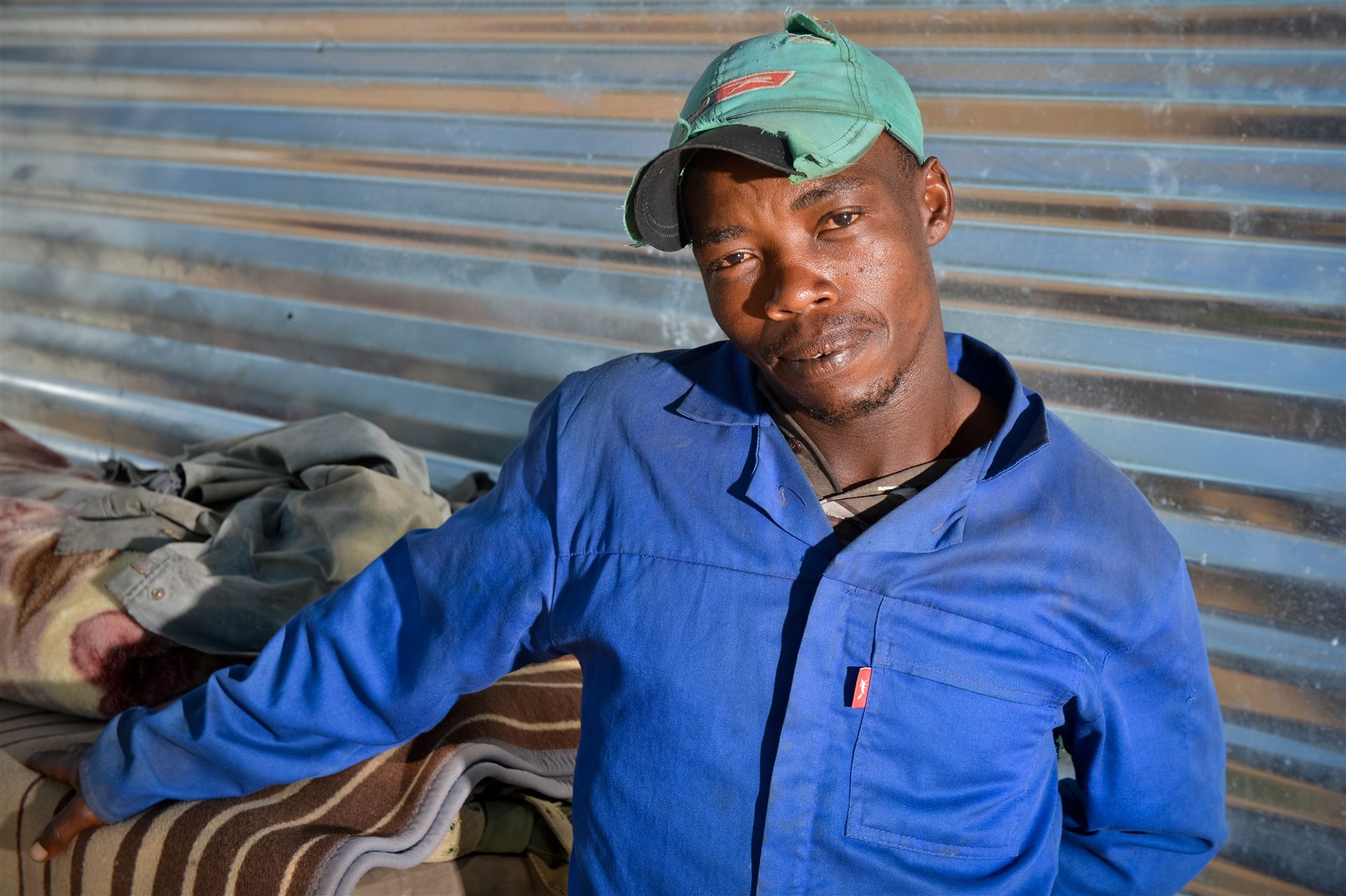 Portrait of a ranch worker in blue overalls